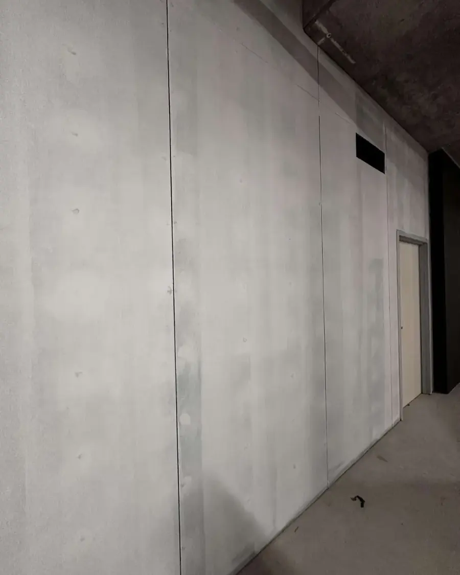 Large precast panel wall with exposed concrete ceiling in a new build