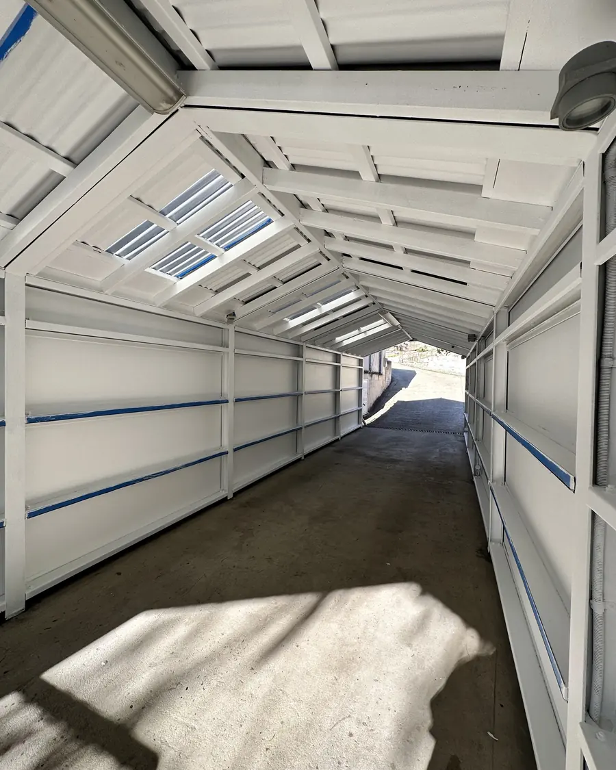 Long covered structure with a clean white painted finish