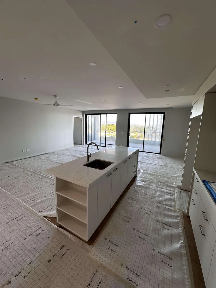 Freshly painted open-plan apartment with kitchen island on the Gold Coast