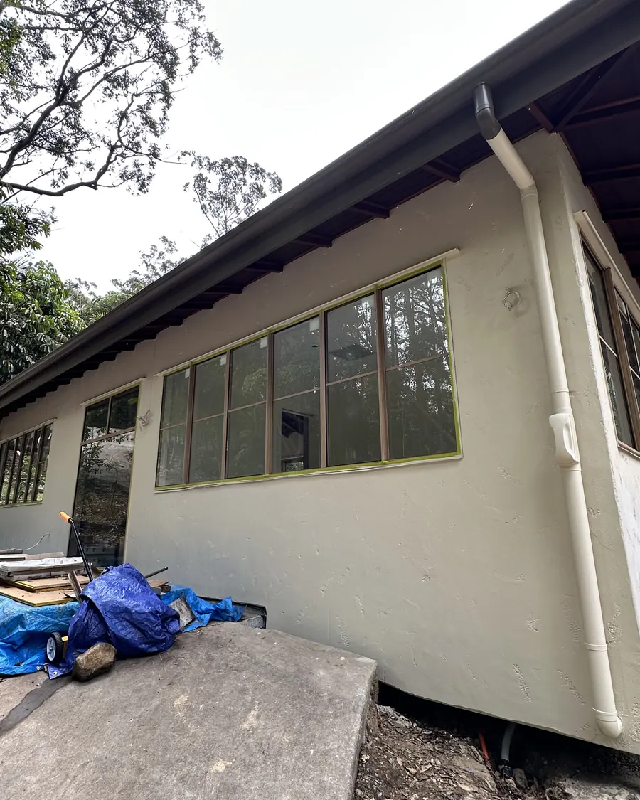 Exterior repaint in progress on a rendered Gold Coast home