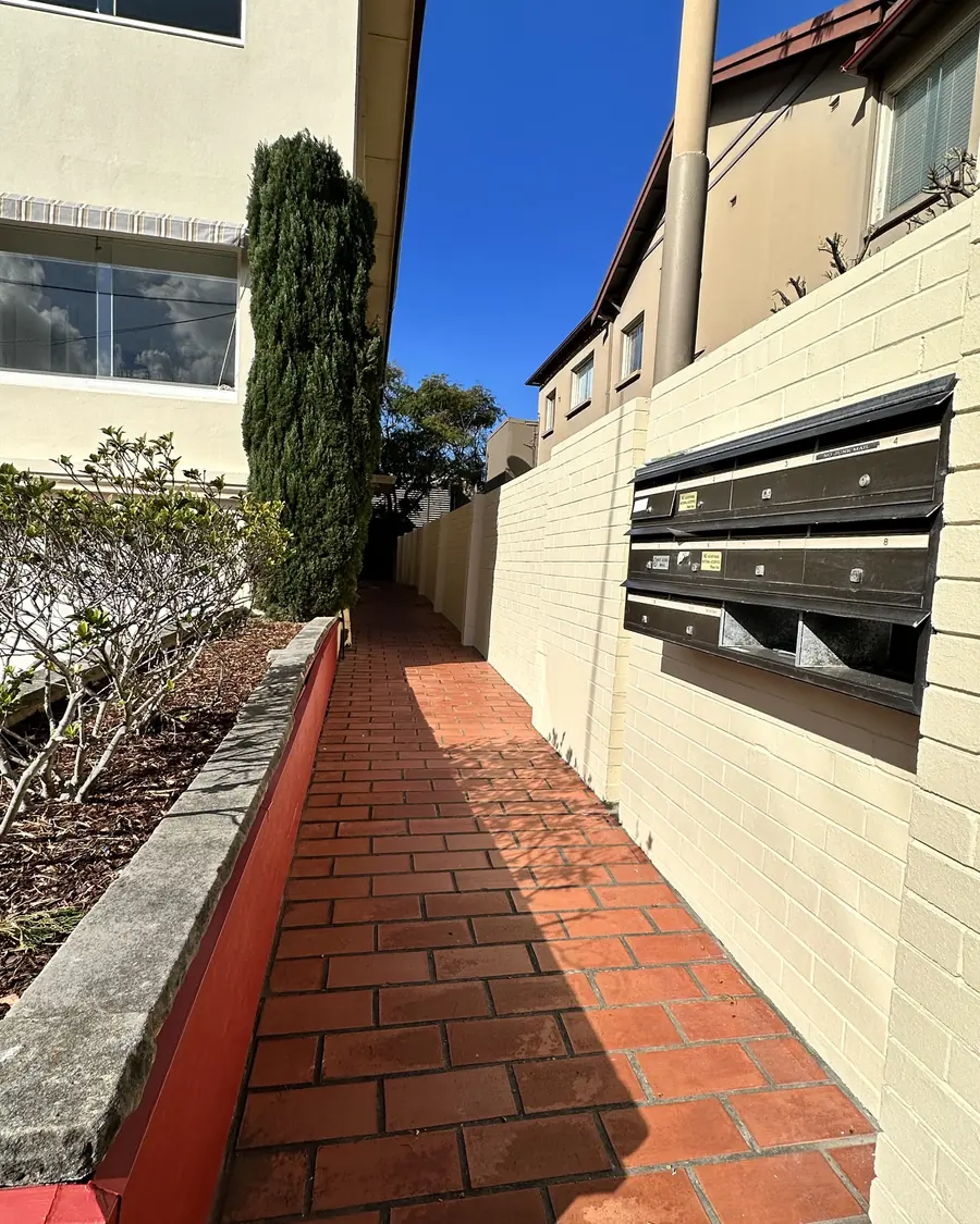 Apartment building entry walkway and boundary wall
