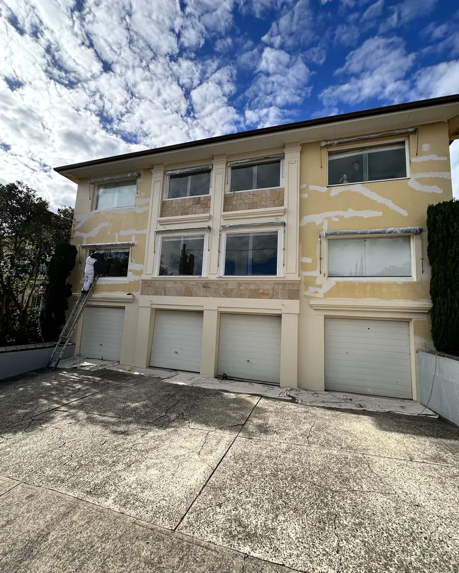 Apartment facade patched and prepared ahead of repainting