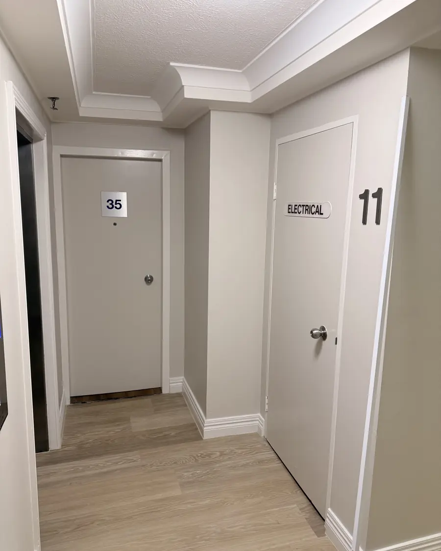 Unit doors and hallway painted in a strata building